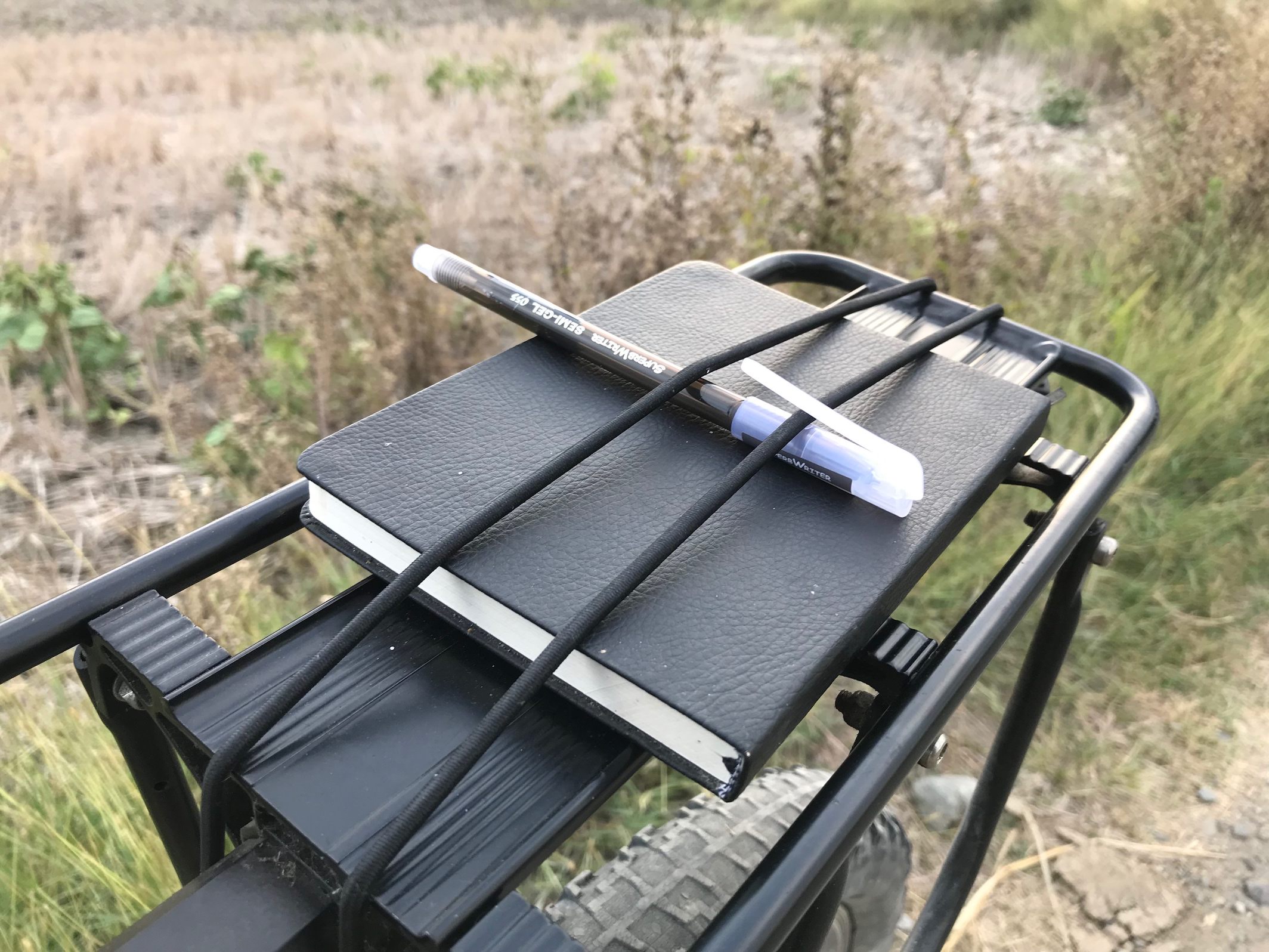 Field notes and pen strapped on my bike carrier