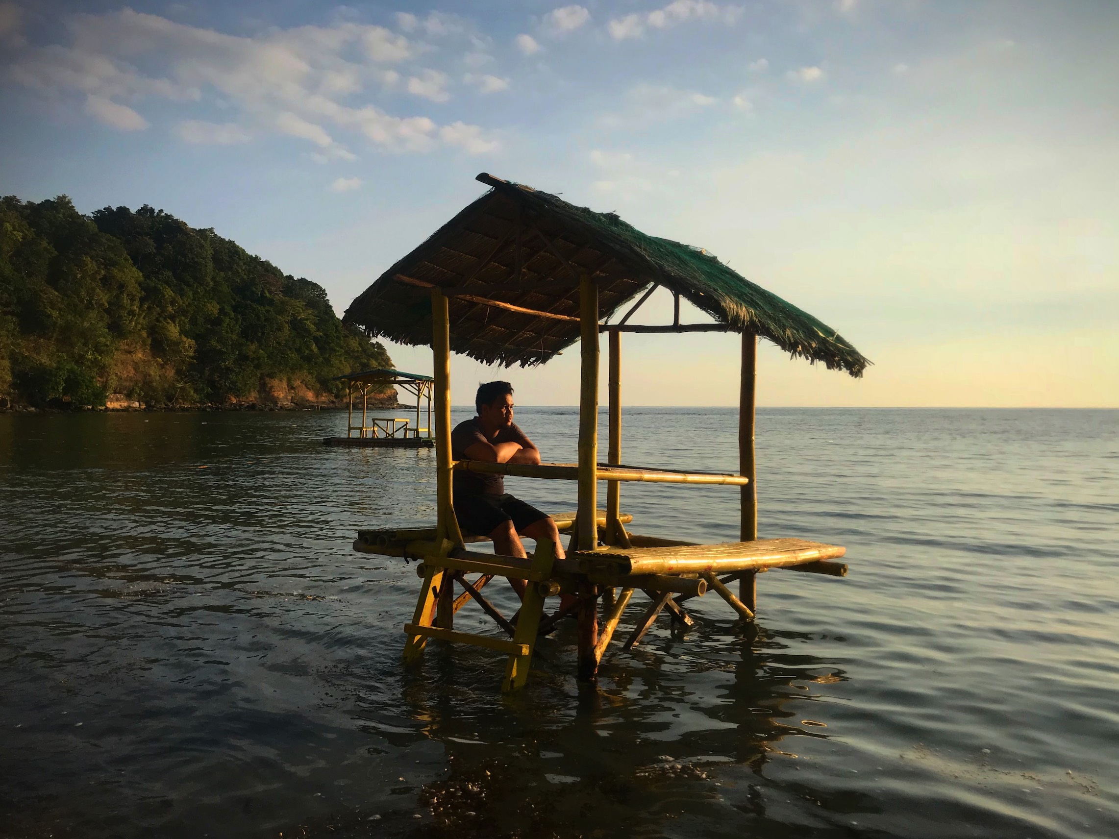 Vince Imbat in a kubo at the beach